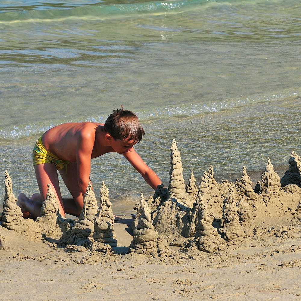 Photo Caption: Watch your kids get creative and play with the fine sand